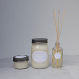 Small candle, large candle, and reed diffuser from the same fragrance collection on a light background.